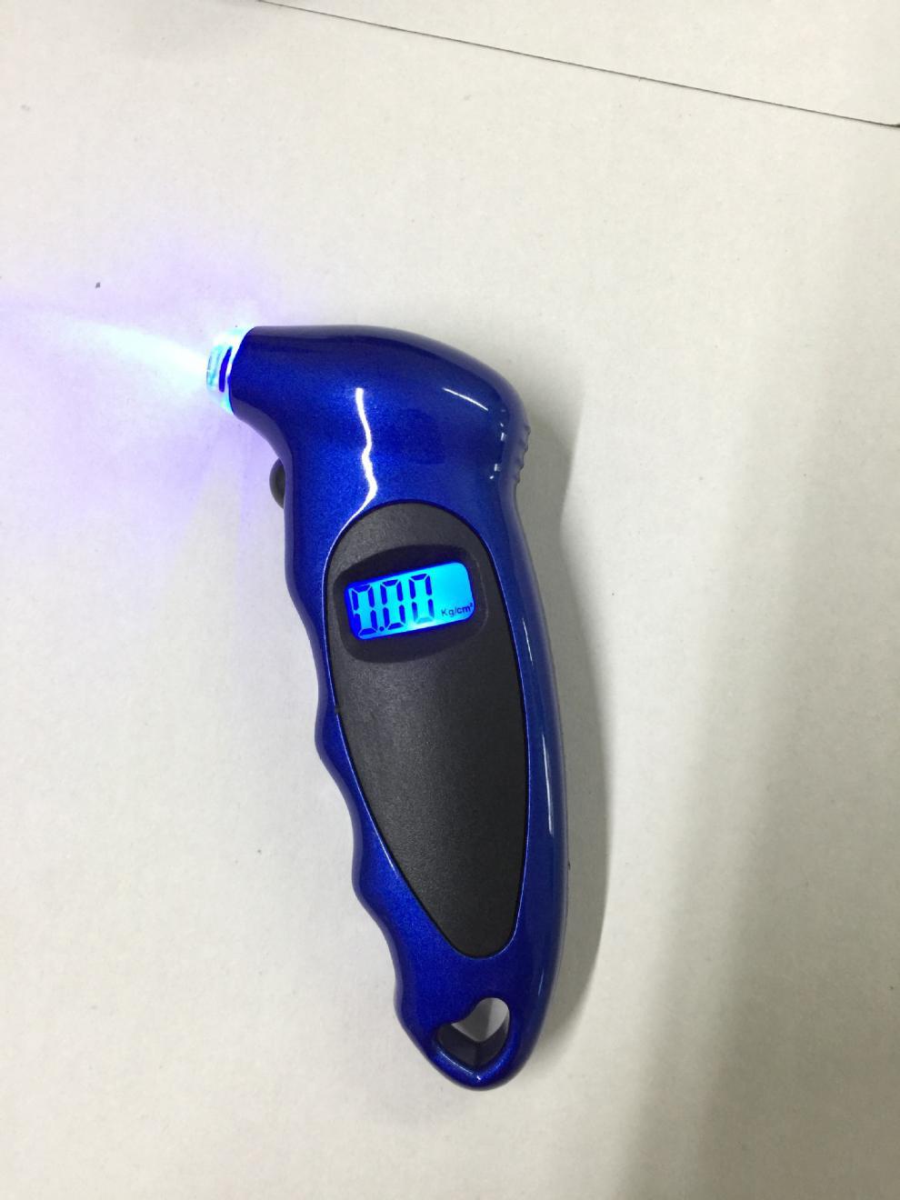 Handheld digital tire gauge close-up