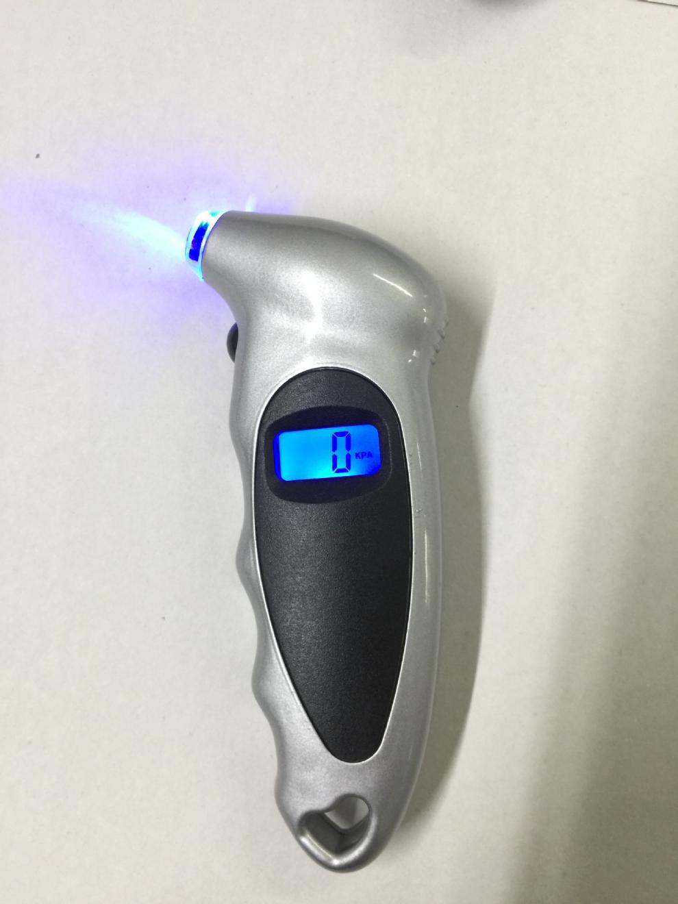 Digital tire gauge checking vehicle